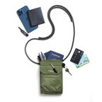 An olive green grid-patterned crossbody phone pouch with a black strap, shown flat-lay with various items inside and around it, including a blue phone, wallet, passport, card, and key, on a white background.