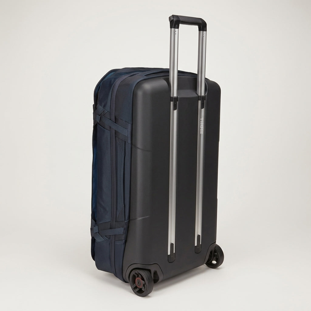 A dark navy blue hard-shell carry-on suitcase with an extended silver telescopic handle and dual spinner wheels, shown on a light gray studio background.